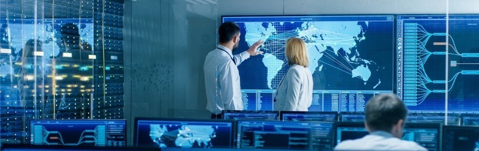 in-the-system-monitoring-room-two-senior-operators-work-on-a-big-map-picture-id949581032